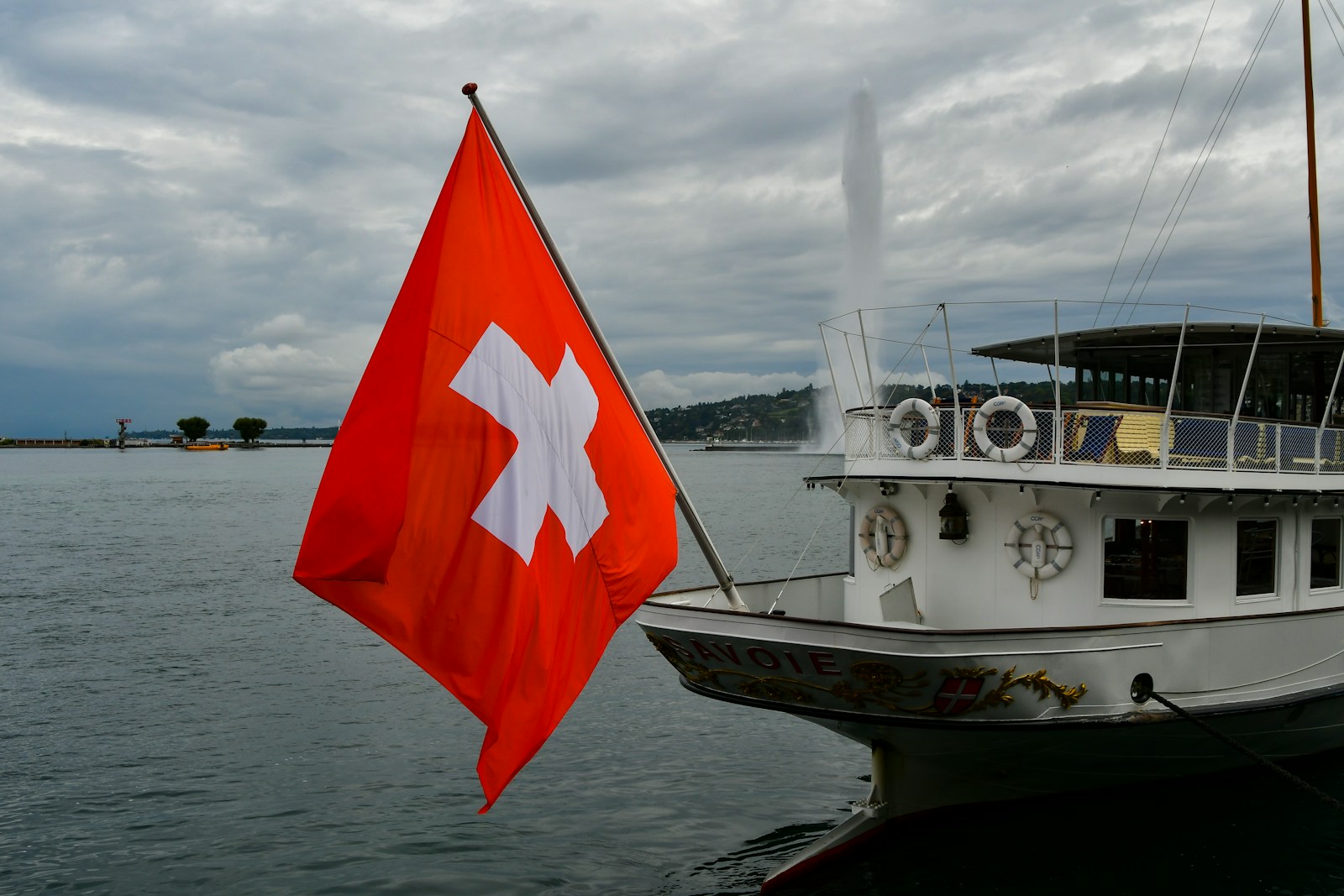 a large white boat with a red and white flag